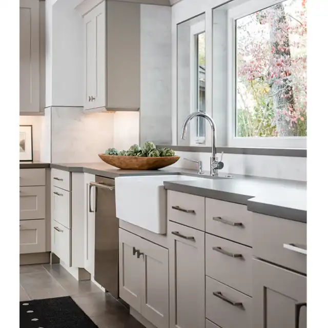 Light Gray Kitchen Cabinet Renovation with Central Island and Pendant Lighting