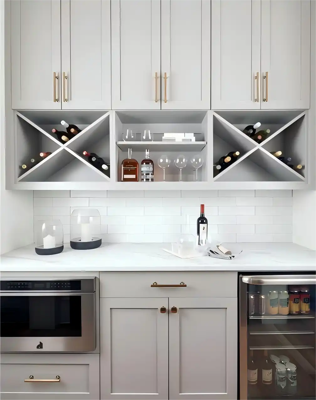 Light gray kitchen wine cabinet with gold hardware, diamond-shaped wine racks, and integrated glassware storage in modern home bar design