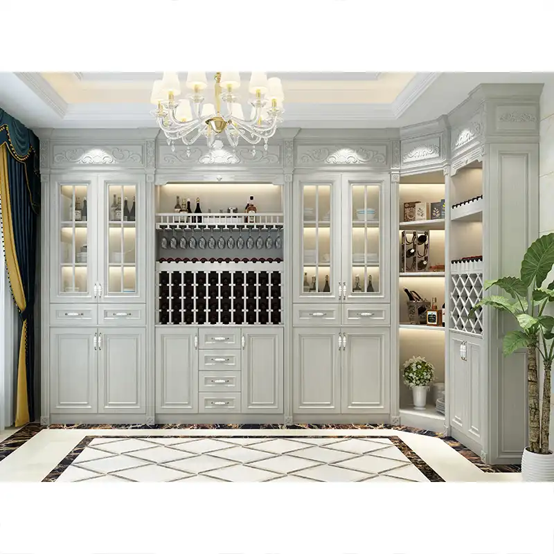 Elegant white wooden wine cabinet with glass doors, brass hardware, wine bottle storage racks, and decorative display shelves in luxury home interior