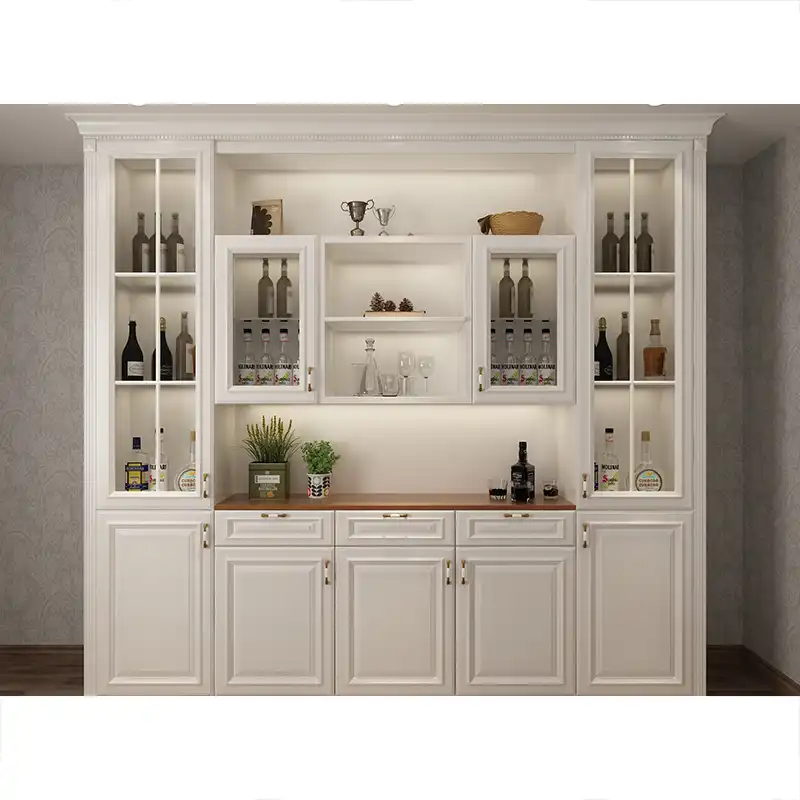 Elegant white wooden wine cabinet with glass doors, brass hardware, wine bottle storage racks, and decorative display shelves in luxury home interior