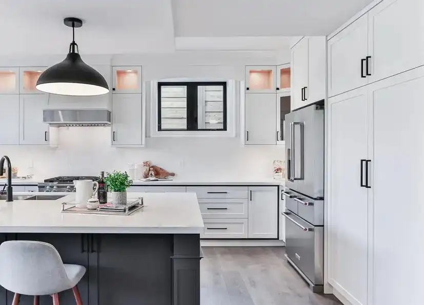 Contemporary white kitchen cabinets ideas with island countertop, black pendant lighting, stainless steel appliances, and gray lower cabinet