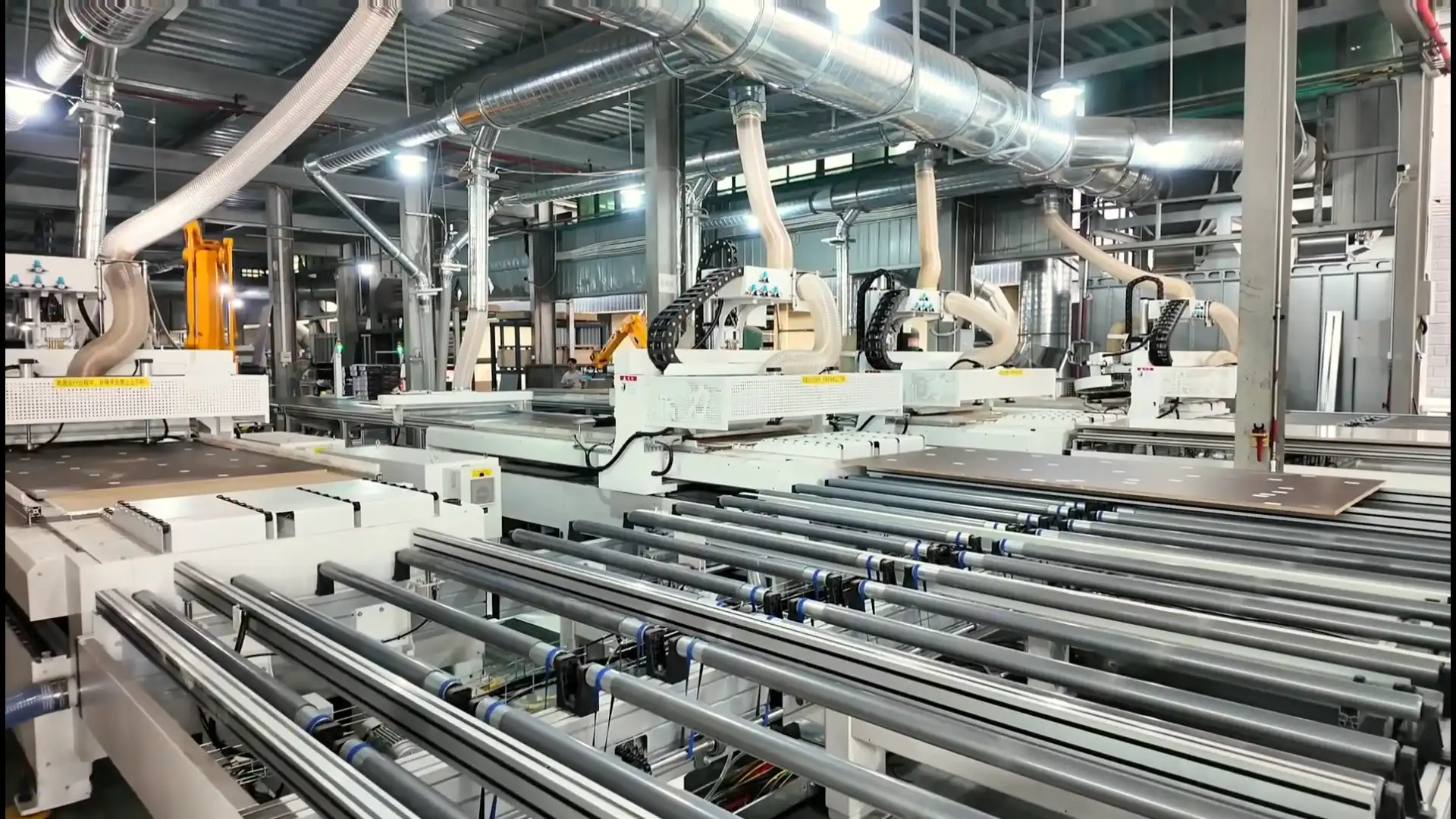 An automated production line in a high-tech Chinese factory manufacturing custom cabinets with CNC machinery and precision assembly systems.