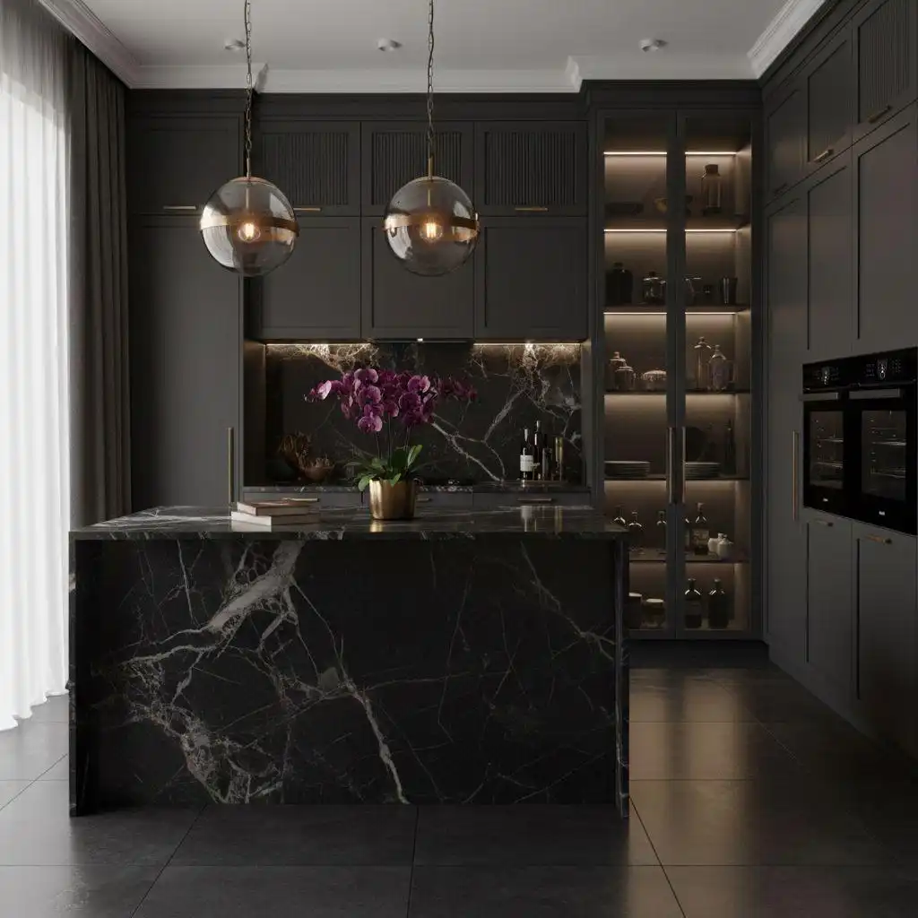 luxury dark gray kitchen with a stunning black marble island, two glass globe pendant lights, and floor-to-ceiling kitchen pantry cabinet storage.