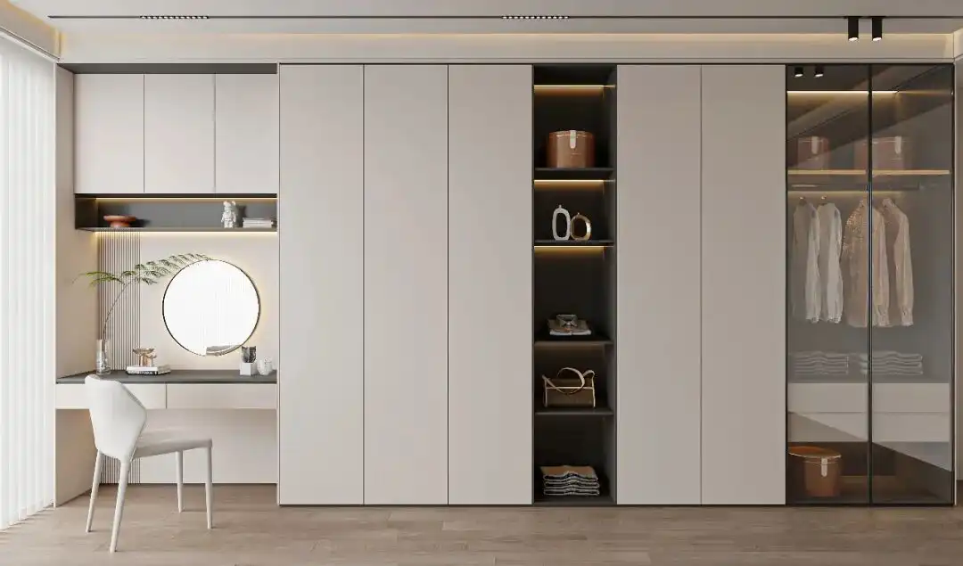 Custom Wardrobe Design 1 Extensive custom wardrobe design covering a full wall, including handle-less cabinets, open shelving for accessories, and a tinted glass closet section.