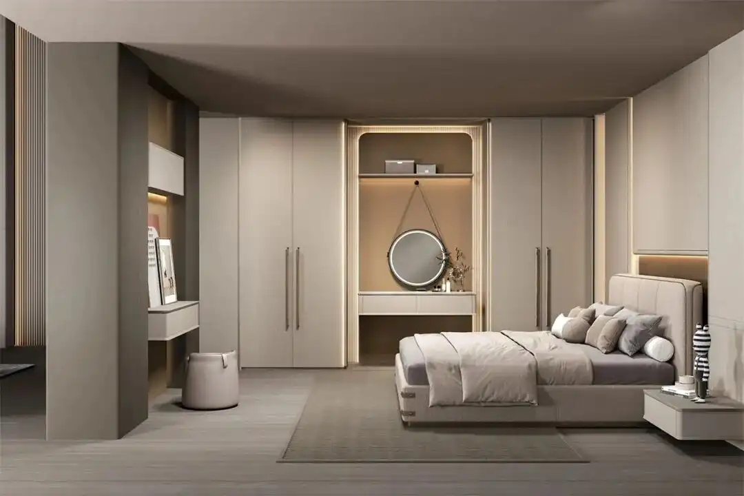 Custom Wardrobe Design 4 A seamless floor-to-ceiling custom wardrobe design in beige with a built-in makeup vanity desk, circular LED mirror, and integrated bedroom lighting.