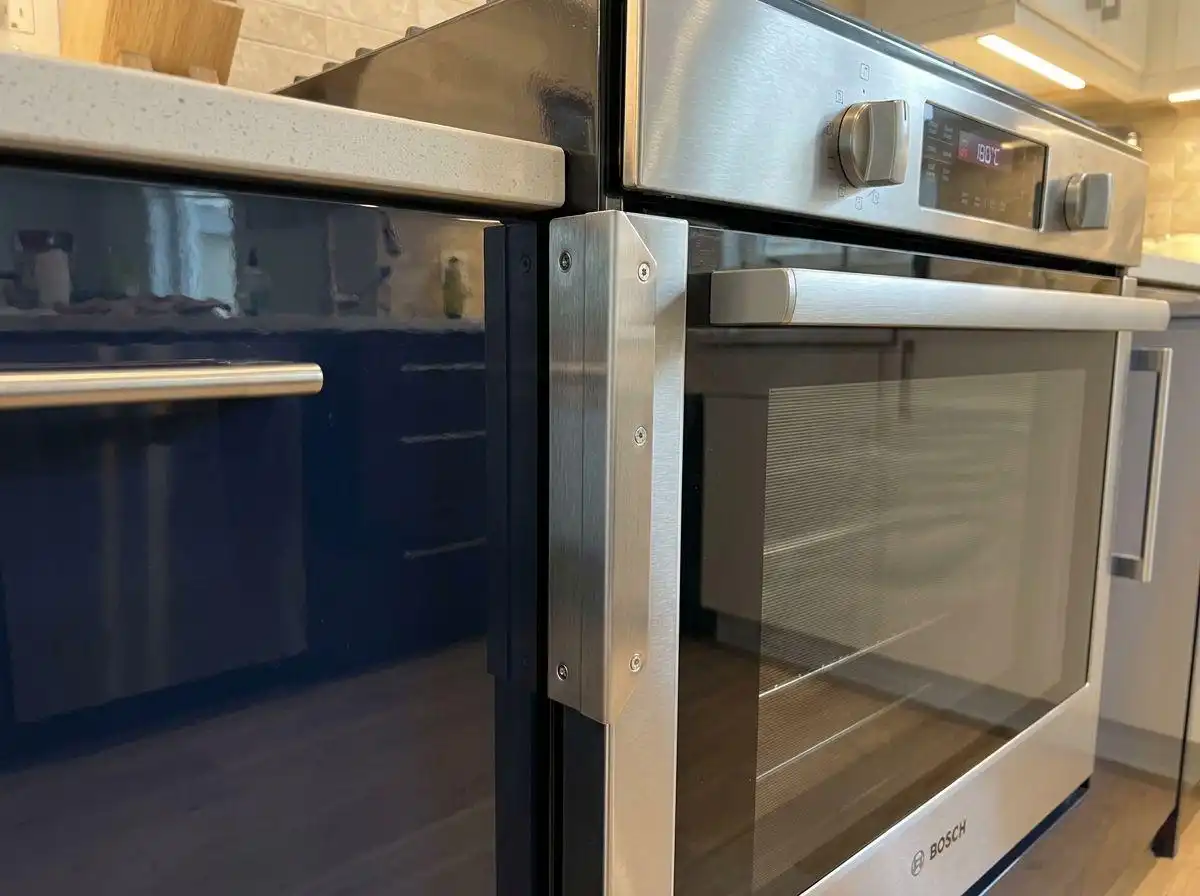 kitchen cabinet layout guide 2 Close-up of a Bosch built-in oven installed next to navy blue high-gloss cabinets, demonstrating a seamless kitchen cabinet layout guide for modern appliances.